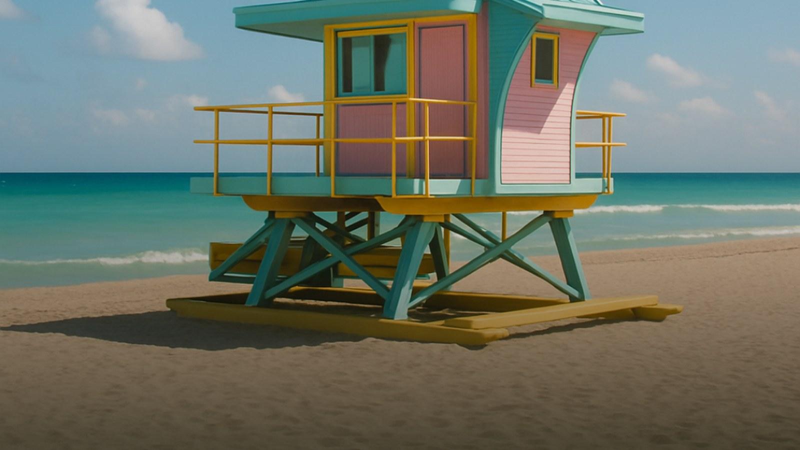 A brightly painted Miami Beach lifeguard tower in warm golden light