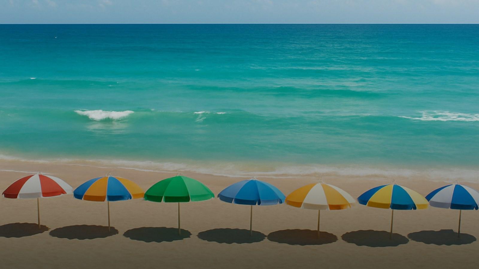 A wide stretch of Miami Beach sand meeting the ocean in golden light