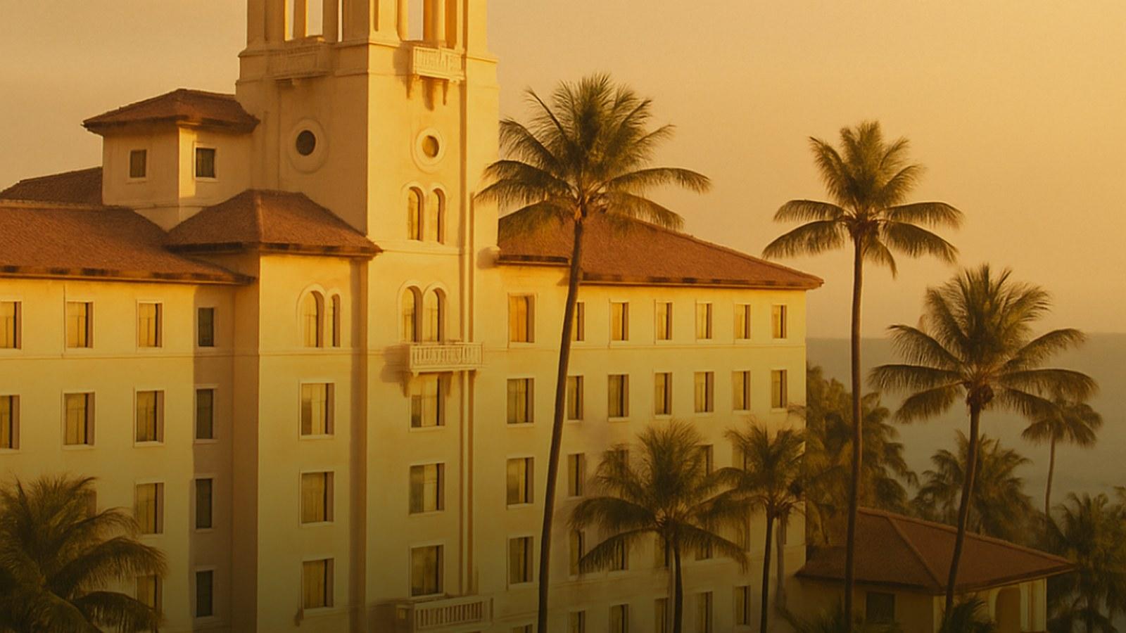 Warm golden light on a Mediterranean revival tower in Miami Beach